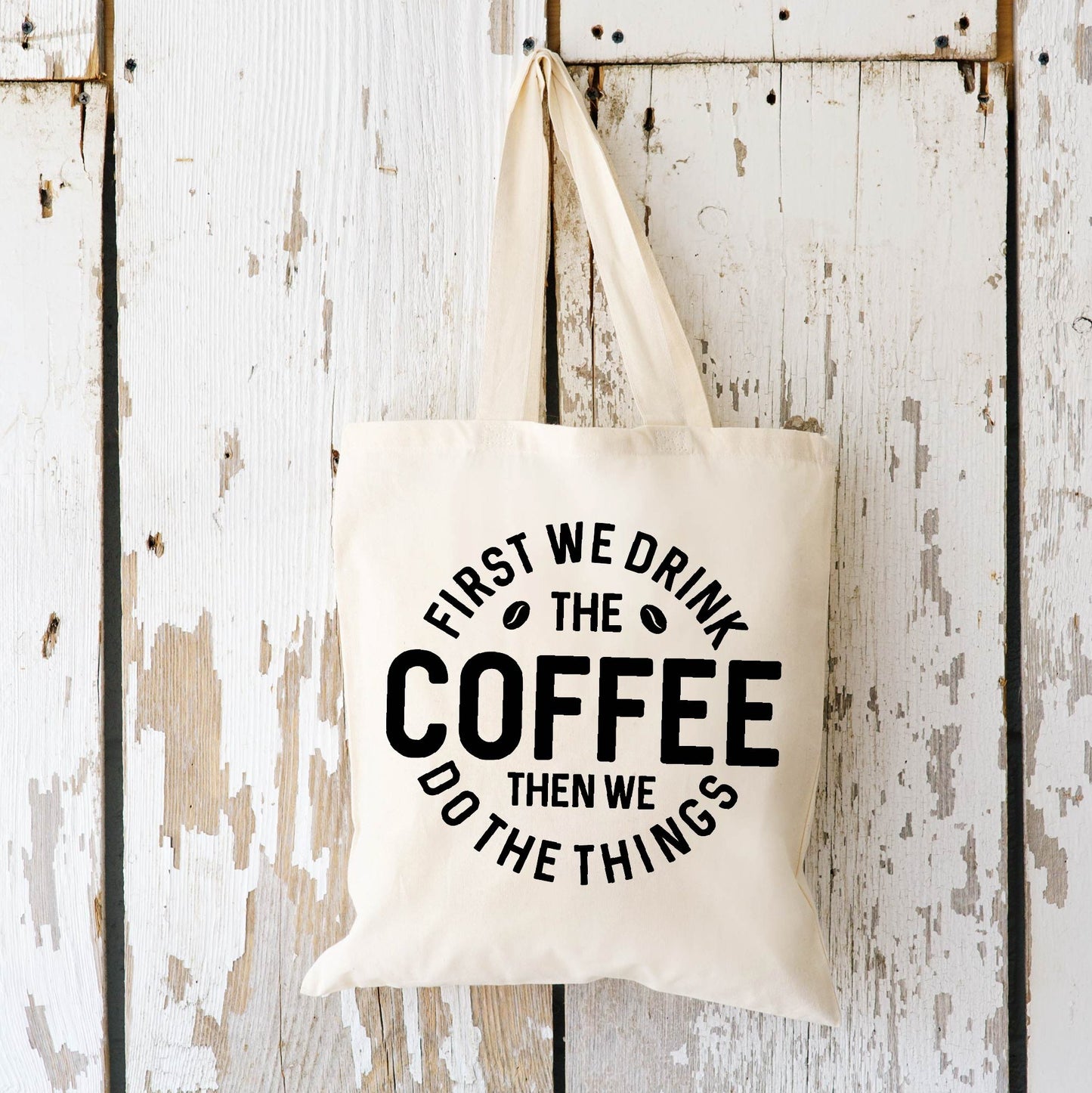 First We Drink the Coffee Tote Bag